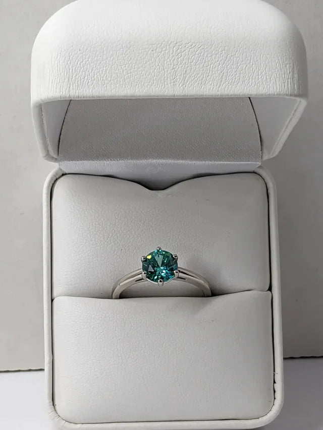Turquoise blue solitaire ring in white leather box